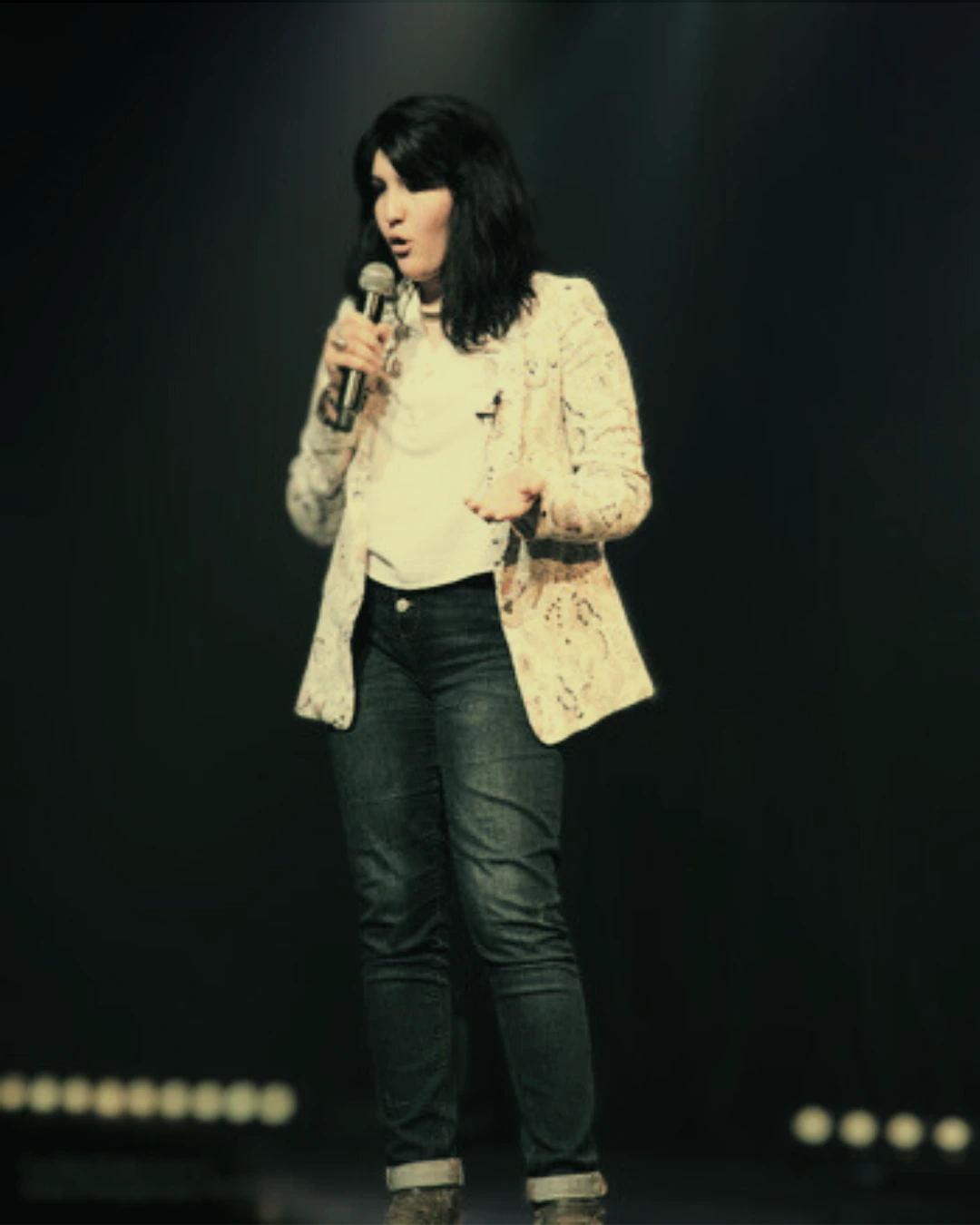Nesrine Kebache speaking on stage at a conference for entrepreneurs and founders